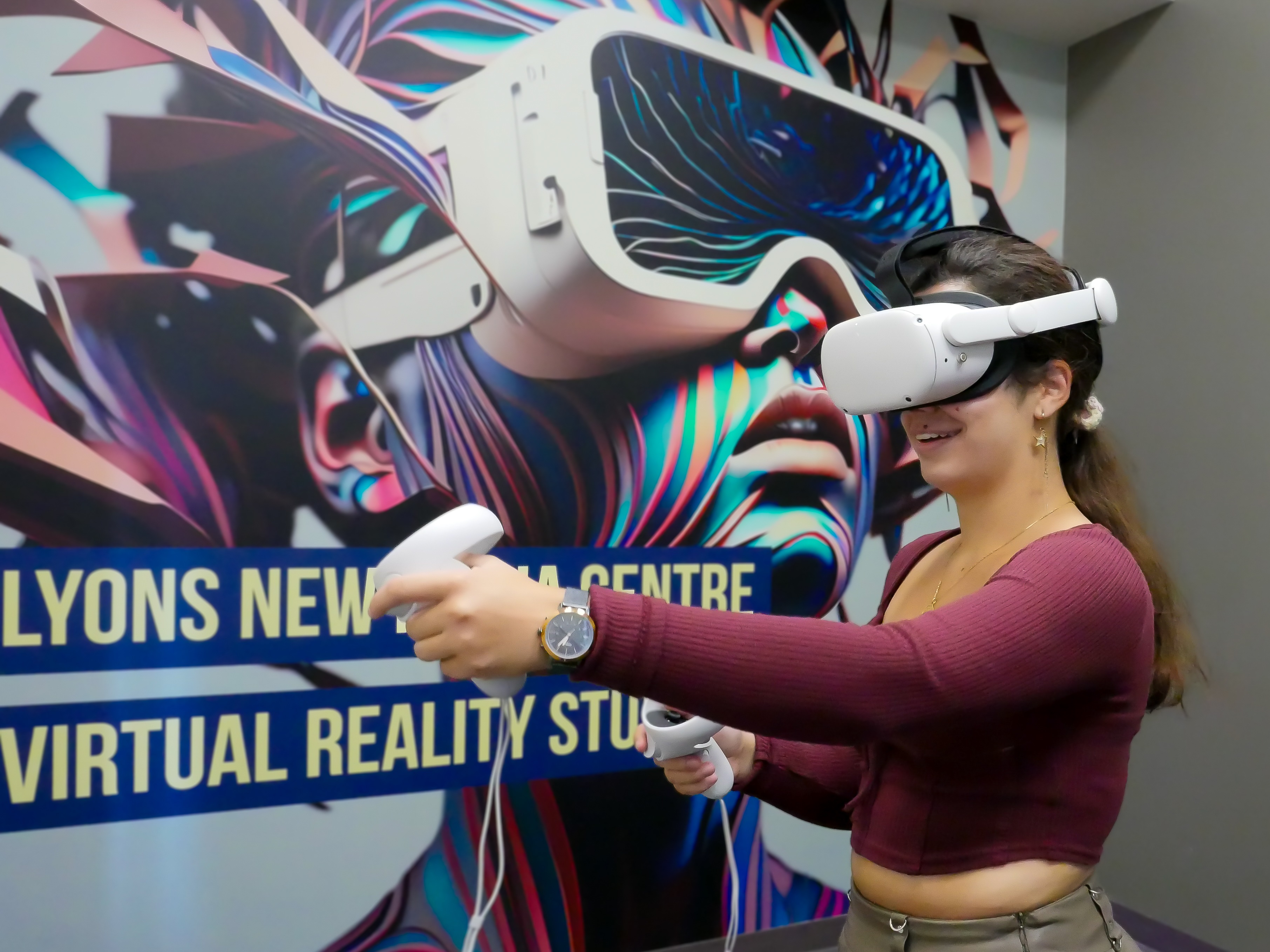 Veronica Larrazabal Zea, third year mechanical and biomedical engineering student, uses a Meta Quest headset and touch controllers in the virtual reality room at Lyons New Media Centre. 